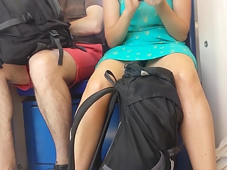 Woman in dress upskirted in train