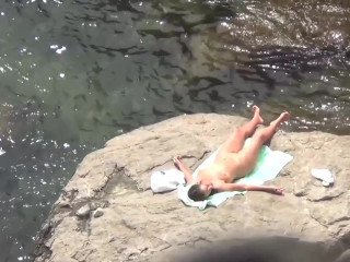 Nudist sunbathing in big rock