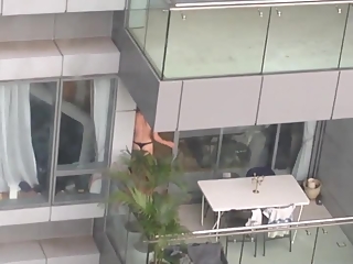 Neighbor spied topless in balcony