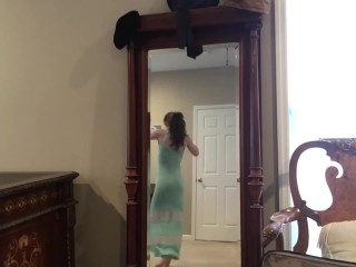 Trying dress in front of mirror