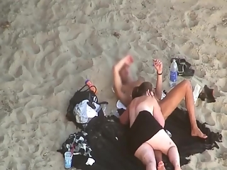 Chubby woman blows cock in the beach