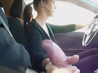 She drives car and strokes cock