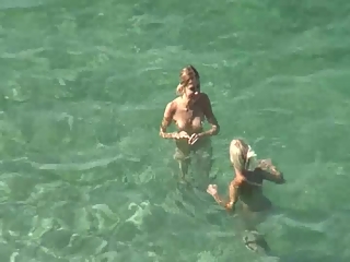 Nudists swimming in the beach