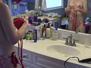 Girlfriend dressing bikini in bathroom