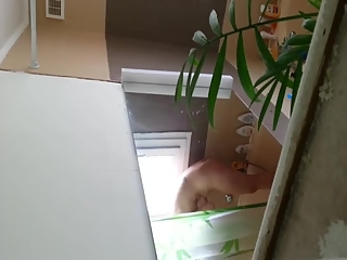 Voyeur films girl taking a shower