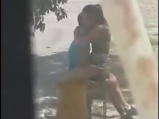 Boy having sex with a girl on a bench