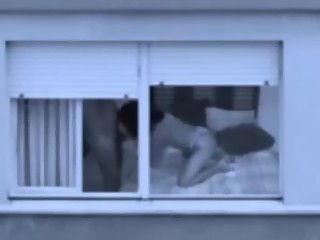 Mature couple fucking by the window