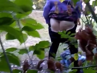 Chubby granny caught in the woods washing