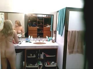 Blonde dressing in bathroom