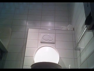 Lady pees hovering the toilet