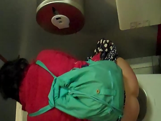 Woman in red jacket pissing