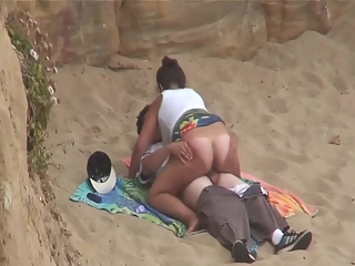 Chubby girl rides boyfriends cock in beach