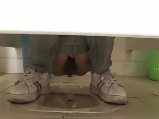 Asian woman in glasses spied in public toilet