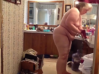 Fat mature woman doing her hygiene
