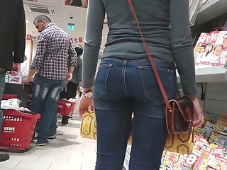 Girl in tight jeans pants at supermarket
