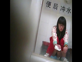 Asian girl in glasses peeing