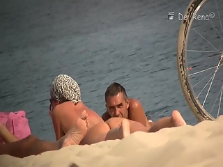 Voyeur at nudist beach films nude men and woman