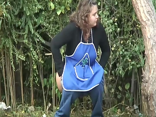 Chubby woman peeing outdoors