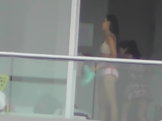 Voyeur films two girls in building across the street