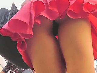 Brunette girl in short pink skirt upskirted