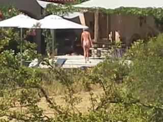 Nude couple in their vacation house