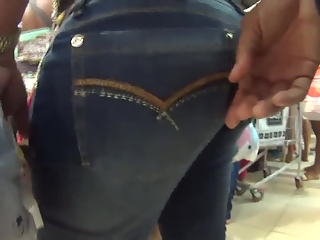 Guy gropes woman's ass in tight jeans pants