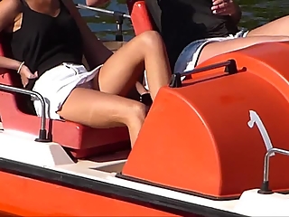 Look under the skirt of nice blonde girl on the boat.
