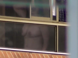 Milf topless by the window