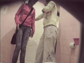 Two friends pissing same time