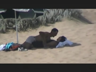 Couple spied in the beach fucking under the sun umbrella