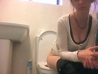 Girl in glasses spied taking a piss