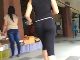 Nerd teen in black leggings walking