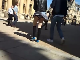 Wind lifts teen short skirt and exposes her ass