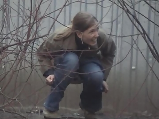 Woman pees beyond shelter