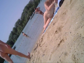 Nude woman sunbathing at beach