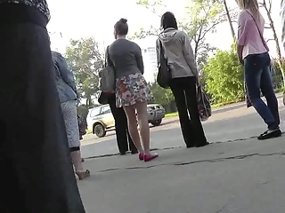 Teen in short skirt waits for bus