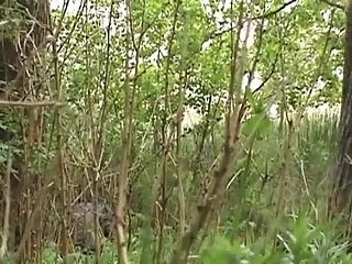 Woman peeing in the middle of bushes