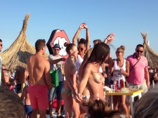 Topless beach gals dancing