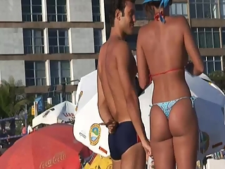 Hot brunette babe in bikini at beach