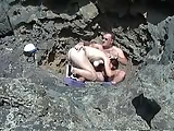 German couple at rocky beach