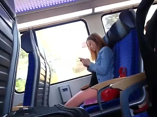 Guy wanks his cock in train next to girl
