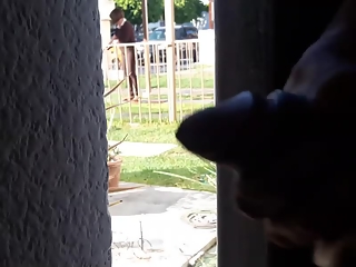 Guy strokes his penis behind door
